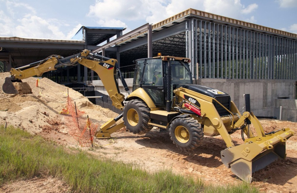 колёсный экскаватор погрузчик Caterpillar 450F